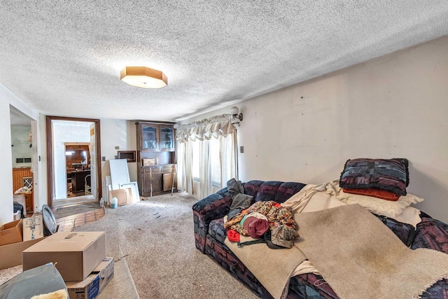 bedroom with a textured ceiling and carpet floors