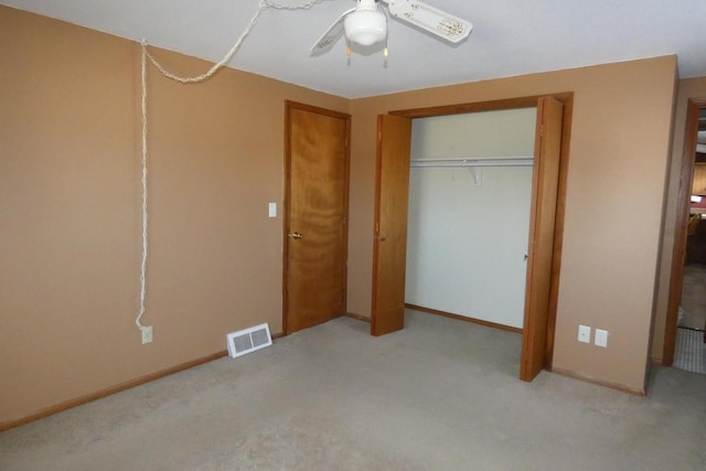 unfurnished bedroom featuring light colored carpet, ceiling fan, and a closet