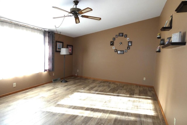 spare room featuring light wood-type flooring and ceiling fan