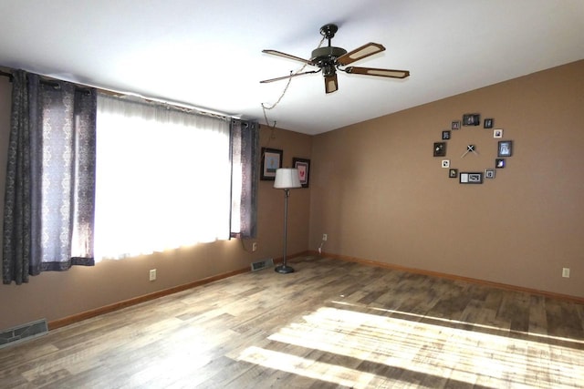 unfurnished room with hardwood / wood-style flooring and ceiling fan