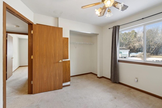 unfurnished bedroom with ceiling fan, light colored carpet, and a closet