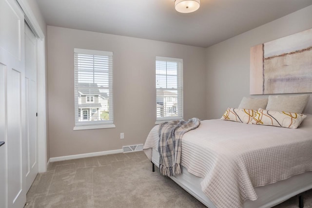 carpeted bedroom featuring a closet