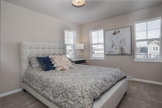 bedroom with dark colored carpet