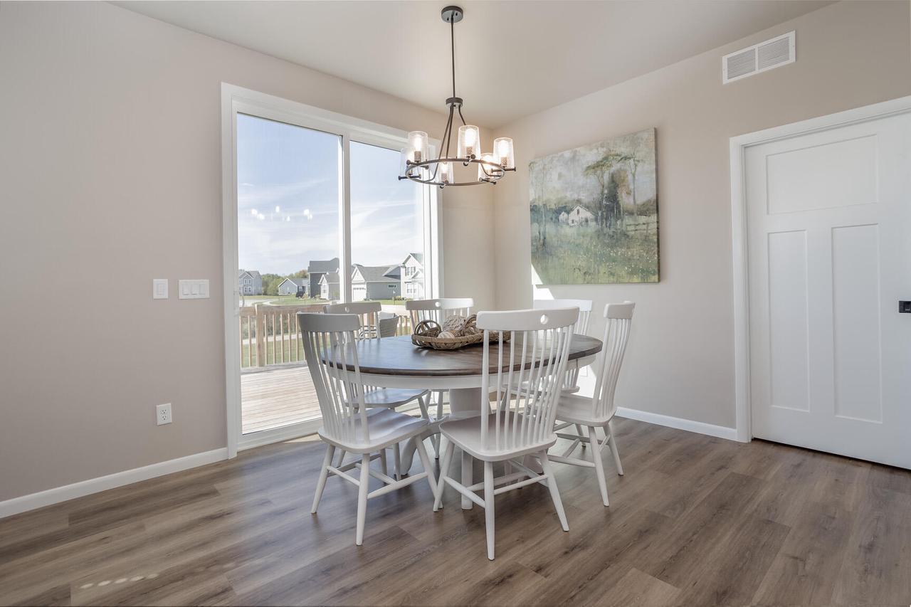 dining room with dark wood-type flooring and a chandelier