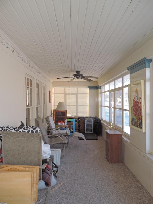 sunroom / solarium with ceiling fan and wood ceiling