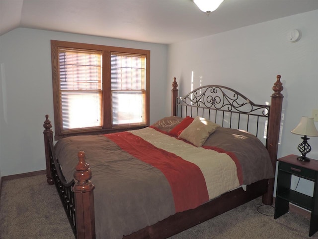 bedroom featuring lofted ceiling and carpet floors