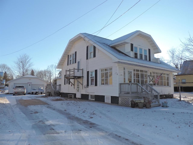 view of front of home with a garage and an outbuilding