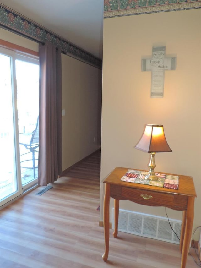 corridor with hardwood / wood-style flooring