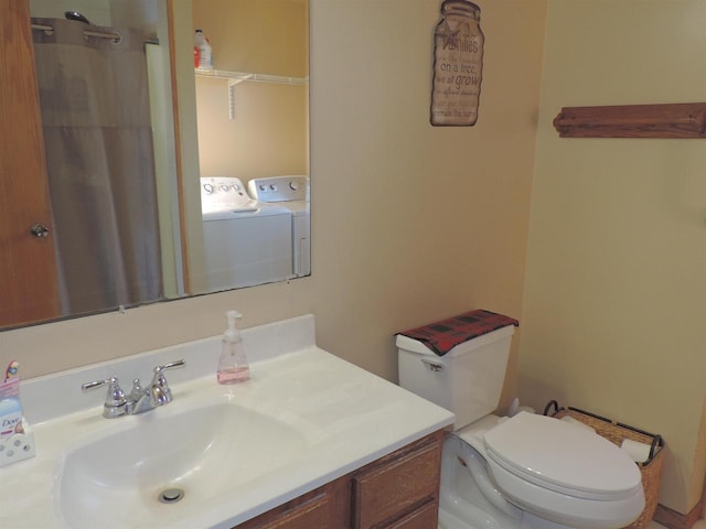 bathroom with washer and dryer, a shower with shower curtain, vanity, and toilet