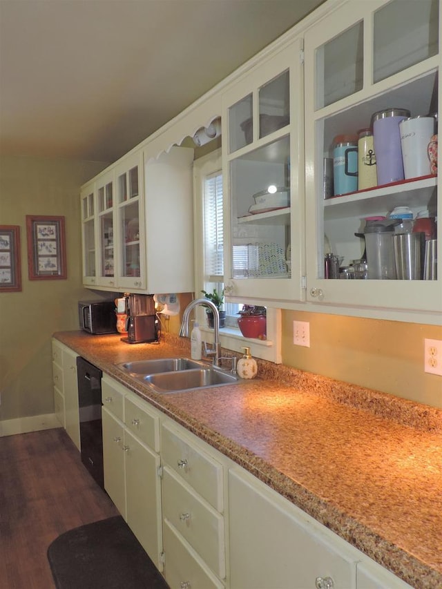 kitchen with dishwasher, green cabinetry, dark hardwood / wood-style floors, sink, and white cabinetry