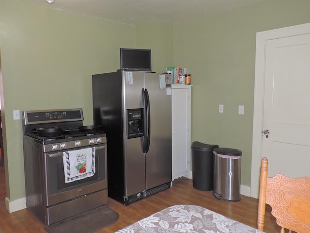 kitchen with stainless steel appliances and dark hardwood / wood-style floors