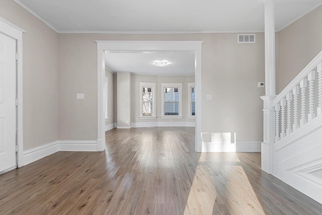 entrance foyer with ornamental molding and hardwood / wood-style floors