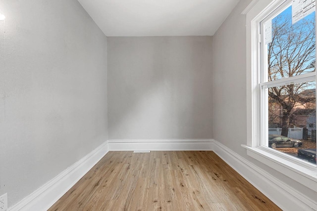 empty room featuring plenty of natural light and light hardwood / wood-style flooring