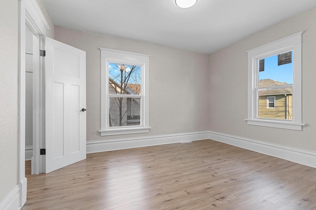 unfurnished room with light hardwood / wood-style flooring