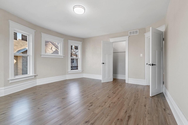 unfurnished bedroom featuring a closet and hardwood / wood-style floors