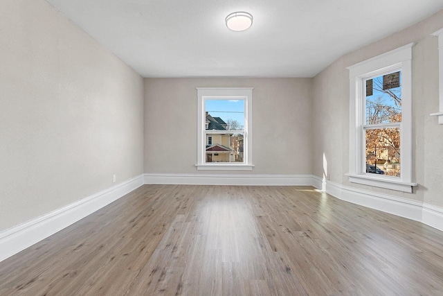 spare room with light hardwood / wood-style flooring