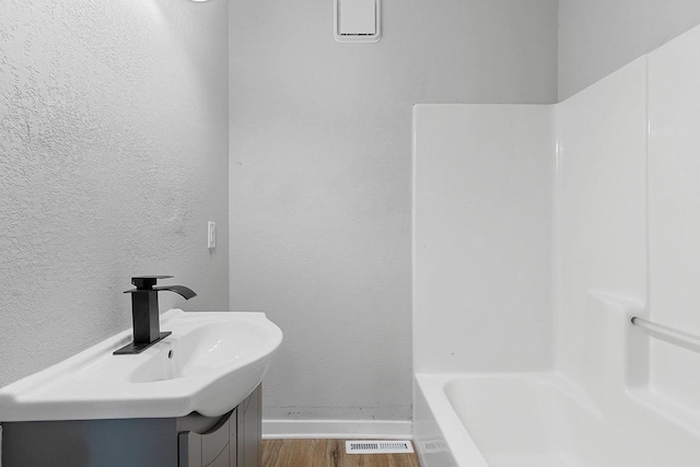 bathroom featuring hardwood / wood-style flooring and vanity