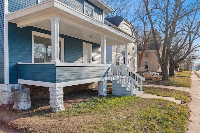 view of side of property featuring covered porch