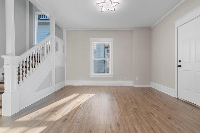 interior space featuring ornamental molding and light wood-type flooring