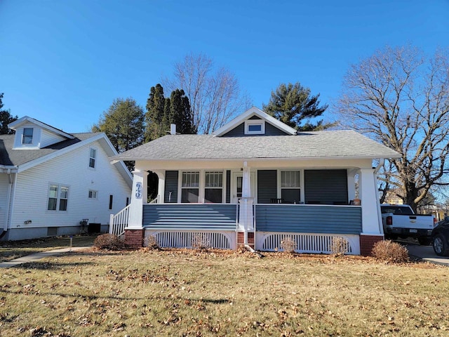 bungalow-style house with a porch and a front yard