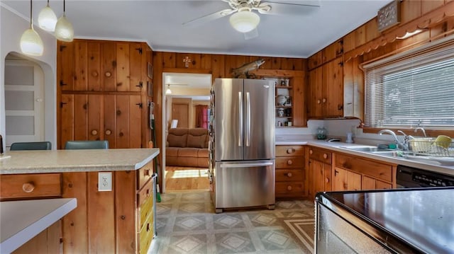 kitchen with ceiling fan, stainless steel fridge, sink, black dishwasher, and decorative light fixtures