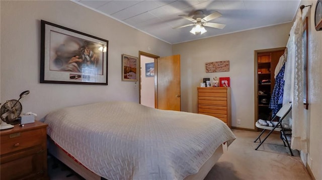 bedroom with light carpet and ceiling fan