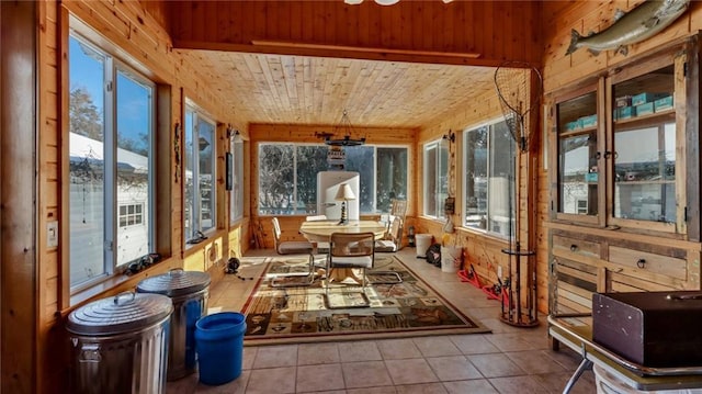 sunroom with a wealth of natural light, wood ceiling, and a mountain view