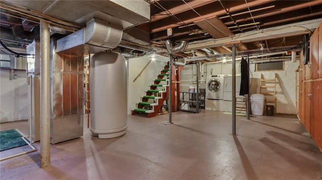 basement featuring washing machine and dryer and gas water heater