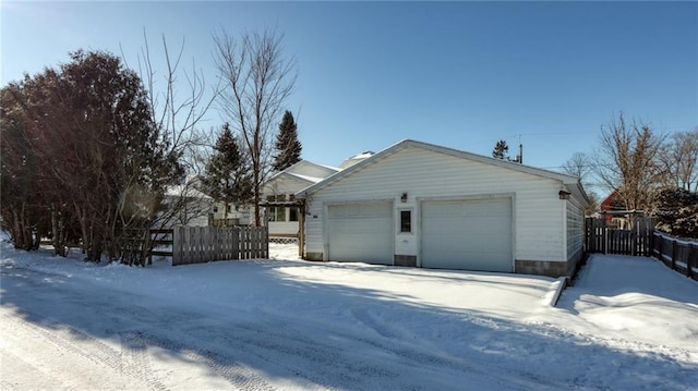 view of snowy exterior featuring a garage