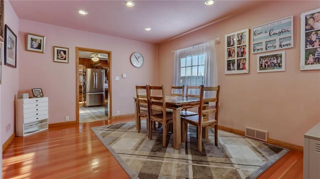 dining room with light wood-type flooring and ceiling fan