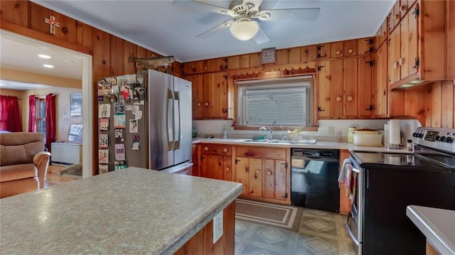 kitchen with stainless steel appliances, ceiling fan, wooden walls, and sink