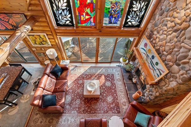 living room featuring log walls and a high ceiling