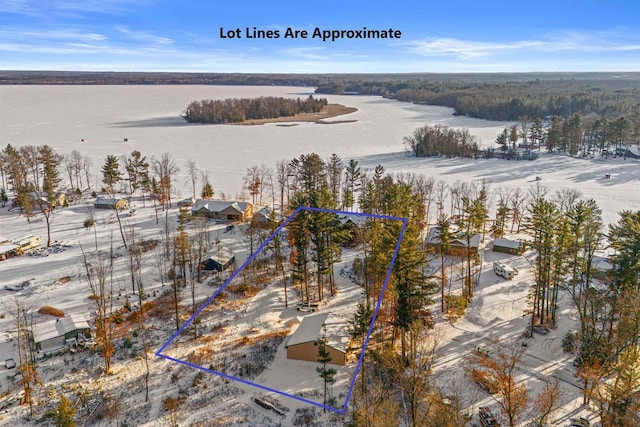 snowy aerial view featuring a water view