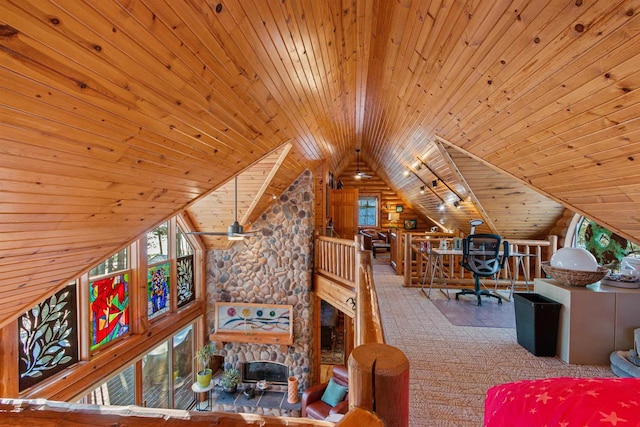 interior space featuring lofted ceiling, a fireplace, and wooden ceiling