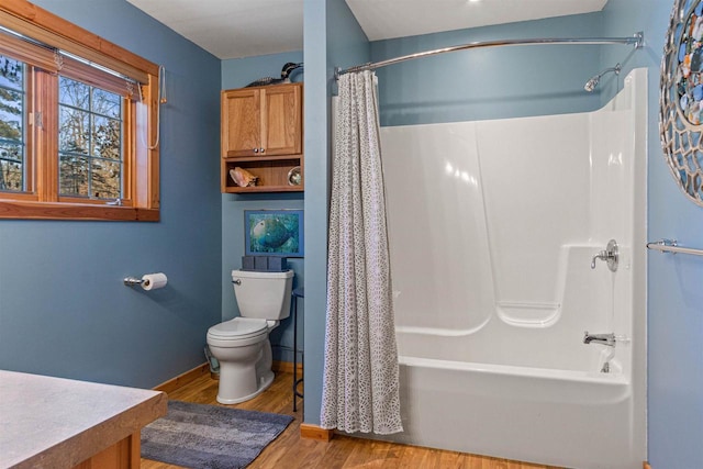 full bathroom with toilet, hardwood / wood-style flooring, shower / bathtub combination with curtain, and vanity