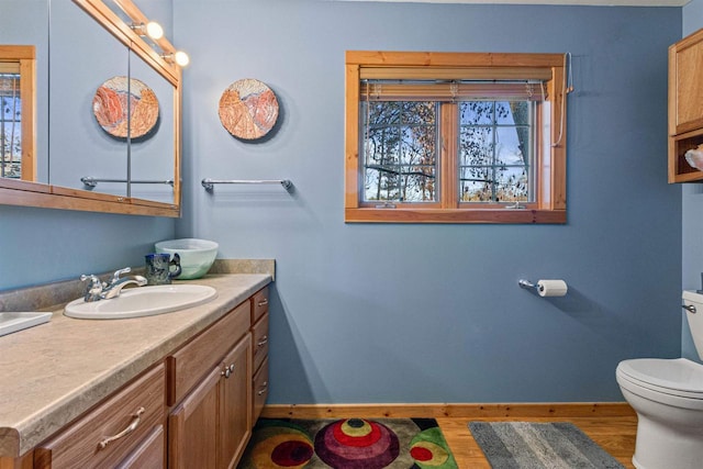 bathroom featuring toilet and vanity