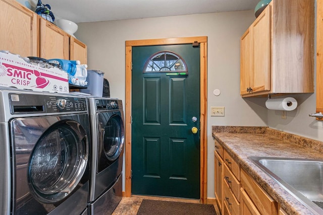 laundry area with sink, cabinets, and independent washer and dryer