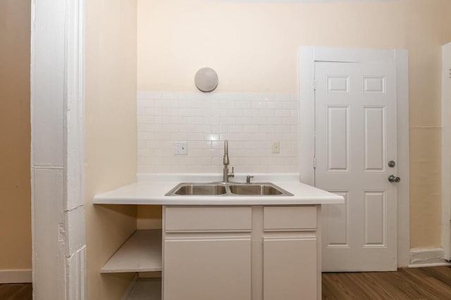 bathroom with backsplash, wood-type flooring, and sink