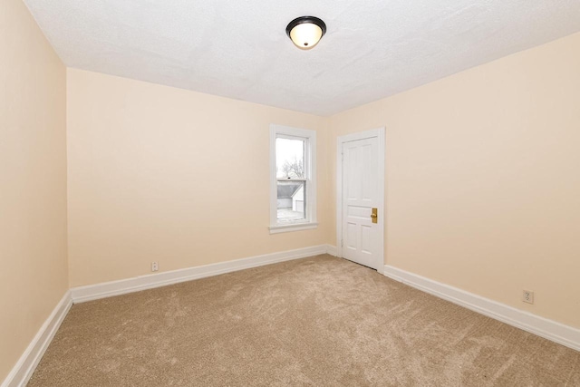 carpeted empty room with a textured ceiling