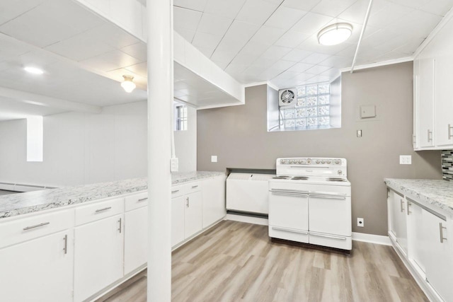 kitchen featuring white cabinetry, double oven range, light hardwood / wood-style floors, and light stone counters