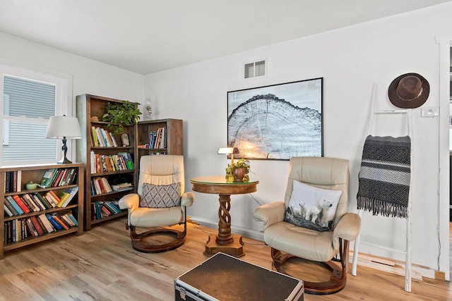 living area with hardwood / wood-style flooring