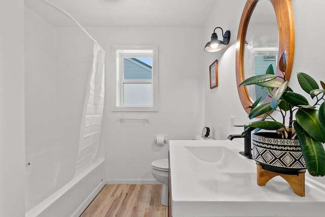 bathroom featuring hardwood / wood-style floors, shower / tub combo with curtain, and toilet