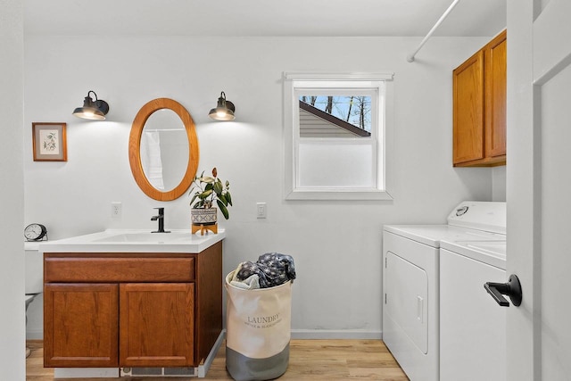 bathroom with washer and dryer, vanity, and hardwood / wood-style floors