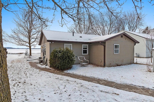 view of snow covered rear of property