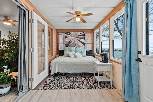 bedroom with ceiling fan and a paneled ceiling