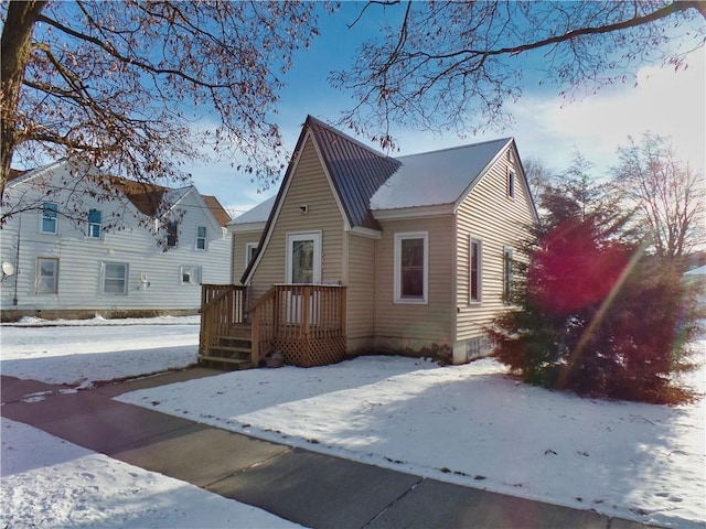 view of snow covered back of property