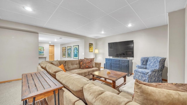 living room featuring a paneled ceiling and carpet flooring