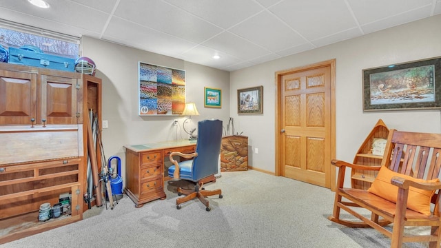 carpeted office space featuring a paneled ceiling