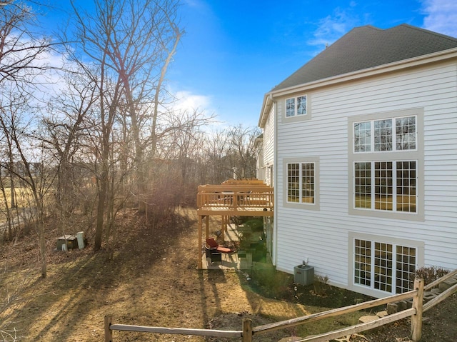 view of home's exterior with a deck and central AC