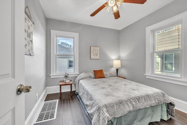 bedroom with ceiling fan and dark hardwood / wood-style floors